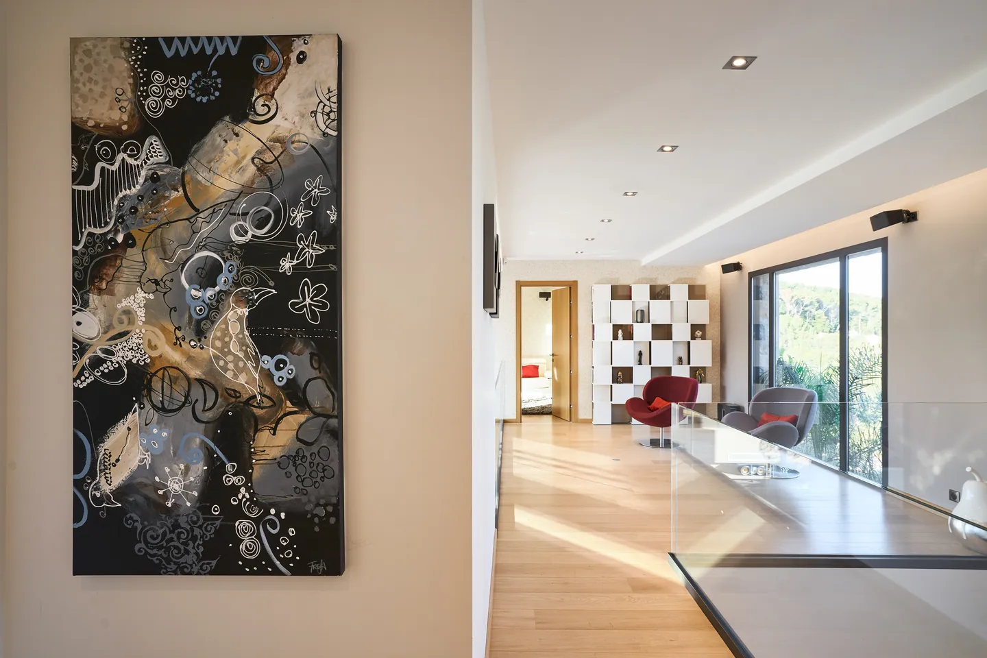 Large contemporary painting and parquet corridor along the mezzanine