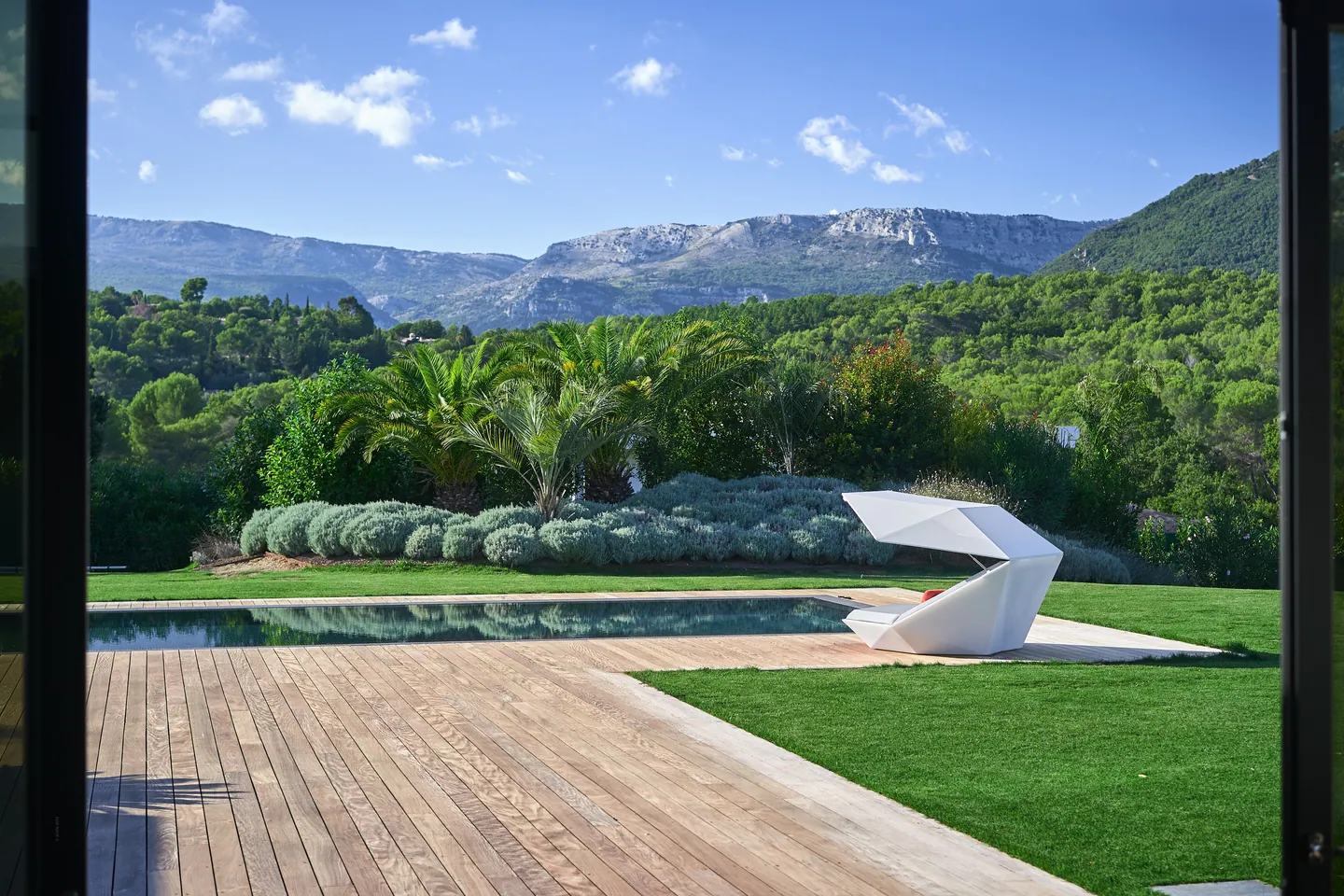 View from the living room over the timber deck, pool and mountains