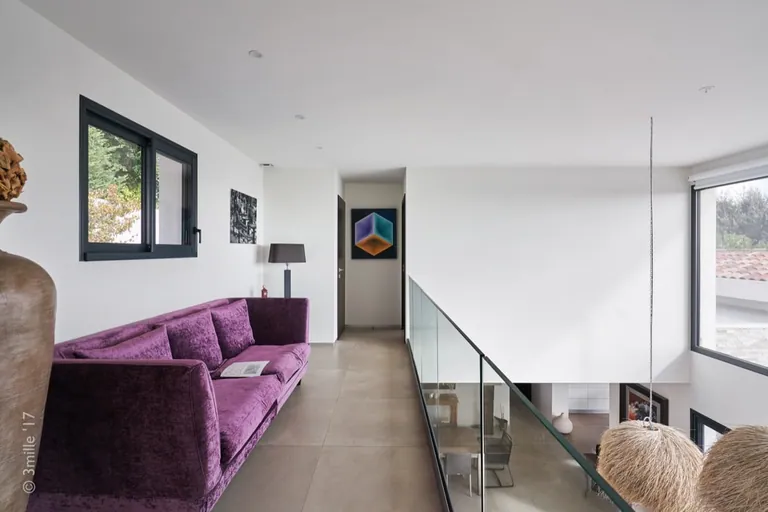 Mezzanine with glass balustrade overlooking the living room