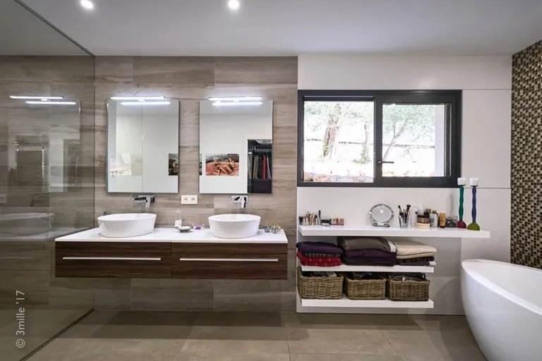 Wall-hung double vanity, open shelving and window onto the garden