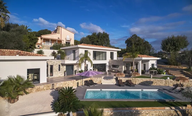 Main house and single-storey wings behind the pool, dry-stone retaining walls