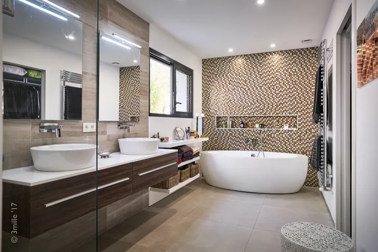 Bathroom with freestanding bathtub, double vanity and mosaic wall
