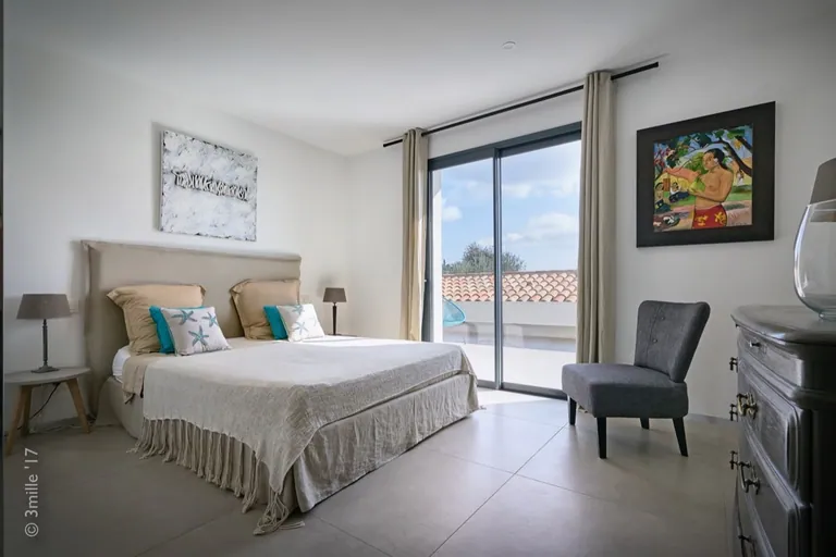 Bright bedroom with sliding door onto a roof terrace