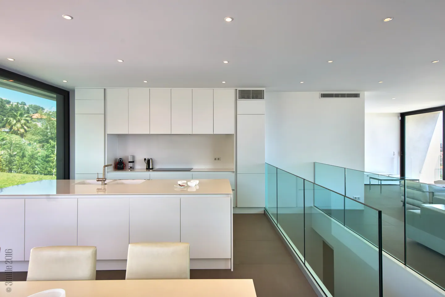 Minimalist white kitchen with island, full-height storage and glass balustrade
