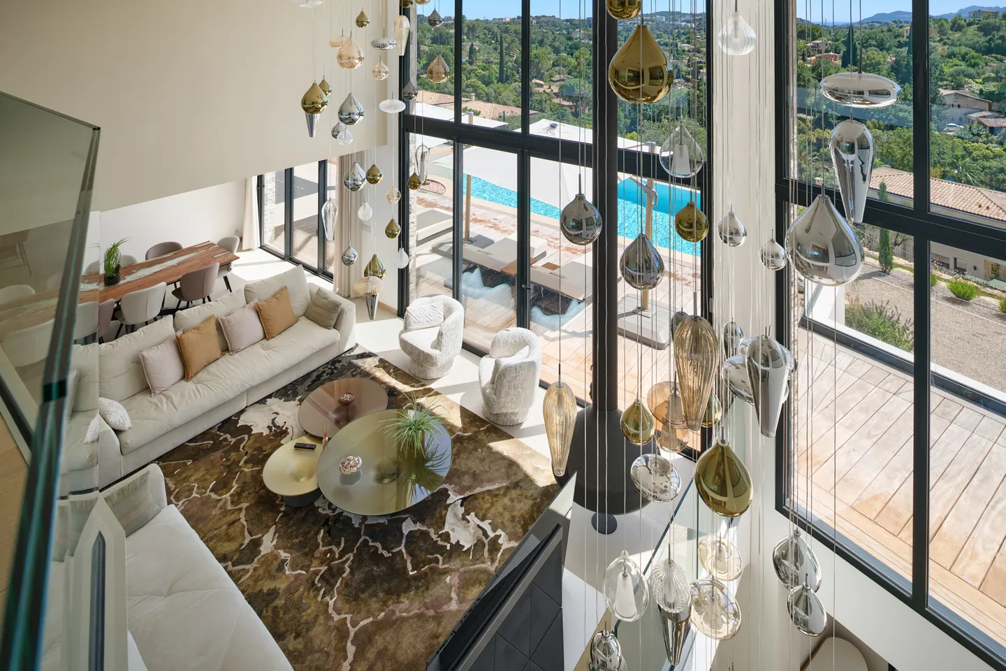 Vue plongeante depuis la mezzanine sur le salon, la terrasse et la piscine